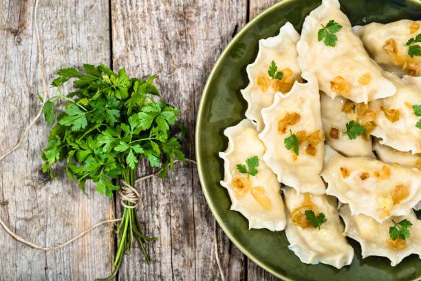 Homemade dumplings with fried onion on plate, top view, cooking concept Homemade dumplings with fried onion on plate, top view, cooking concept pierogi stock pictures, royalty-free photos & images