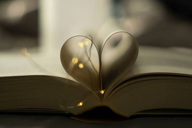 istock Heart-shaped Folded Book Art with fairy lights - valentine's day 1302256160