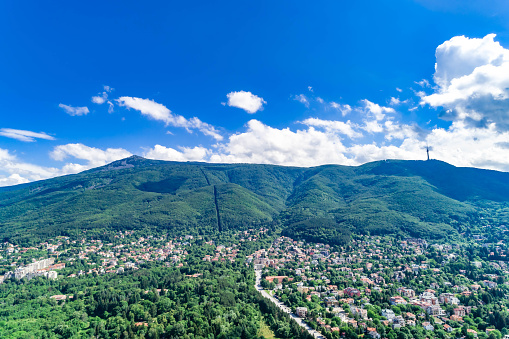 Aerial view of Vitosha mountain and Drgalevci in Sofia, Bulgaria during spring time ( Bulgarian : Планина Витоша и квартал Драгалевци). The scene is situated in Sofia city capital of Bulgaria (Eastern Europe). The picture is taken with DJI Phantom 4 Pro drone.