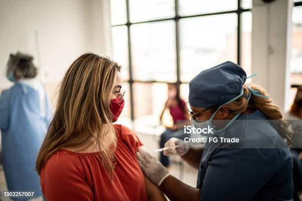 Teenager Girl Being Vaccinated Wearing Face Mask Stock Photo - Download Image Now - Vaccination, COVID-19 Vaccine, Flu Vaccine