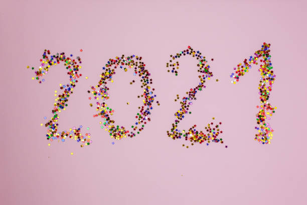 istock 2021 in multicolor little stars on pink background 1302257107