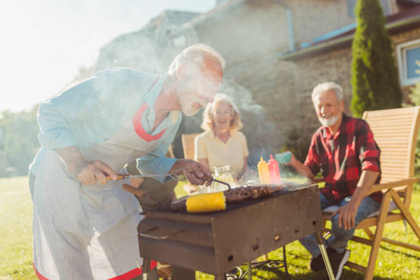 istock Senior neighbors having backyard barbecue party 1302257357