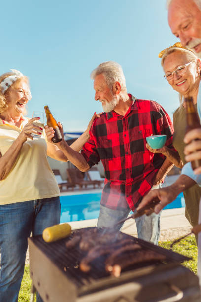 istock Elderly people making a toast at backyard barbecue party 1302257581
