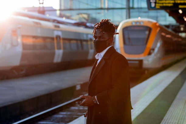 istock Man at a train station using a smartphone 1302257866
