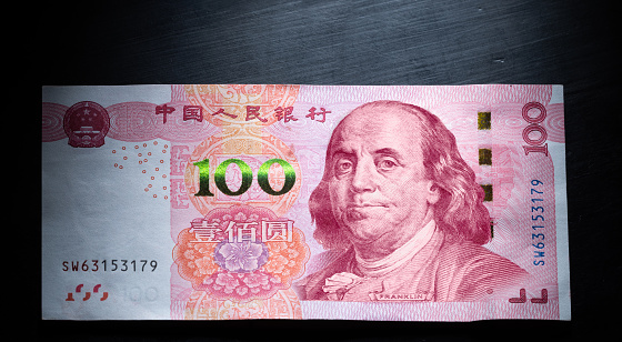 One hundred Chinese yuan bill with the face of Benjamin Franklin on it