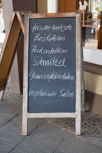 Chalkboard with daily german dishes outside of bistro