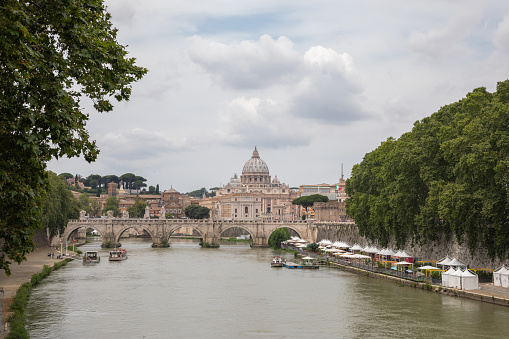 Rome, Italy - June 22, 2018: Panoramic view on the Papal Basilica of St. Peter (St. Peter's Basilica) in the Vatican and river Tiber with bridge in Rome. Summer day