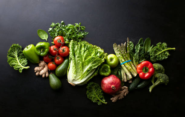 istock Dark culinary background with composition of fresh vegetables 1302262327