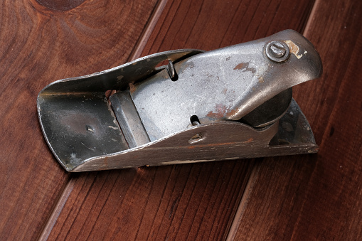 Old metal small plane of the last century close-up on a wooden brown background macro photography