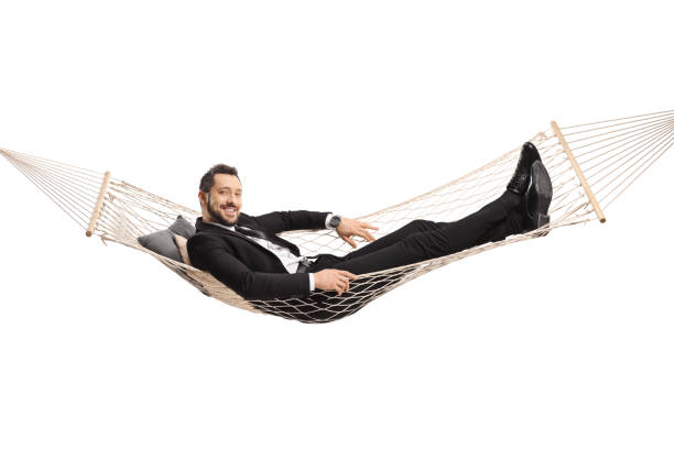istock Businessman lying on a hammock swing 1302263800