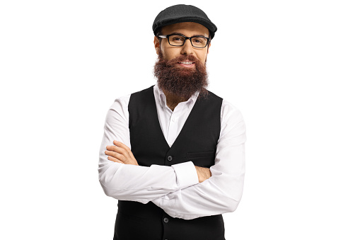 Bearded man hipster in a white shirt and black vest posing isolated on white background