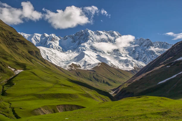 istock View to beautiful mountains covered with snow and green valleys on a nice spring day 1302263928