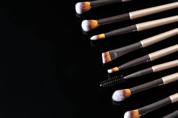 istock Collection of make up brushes on black background 1302263995