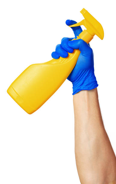 istock hand holding spray bottles isolated against white background. 1302264677