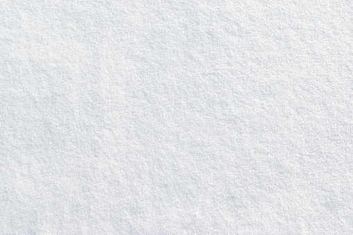 Top view of white fresh snow background. Winter backgrounds, space for copy. Full frame and seamless. Isolated snowflakes.