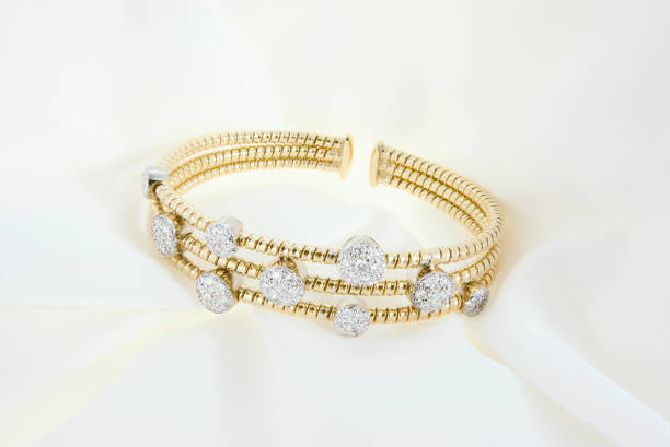 istock Yellow Gold Bracelet With Diamonds On Soft White Background 1302268097