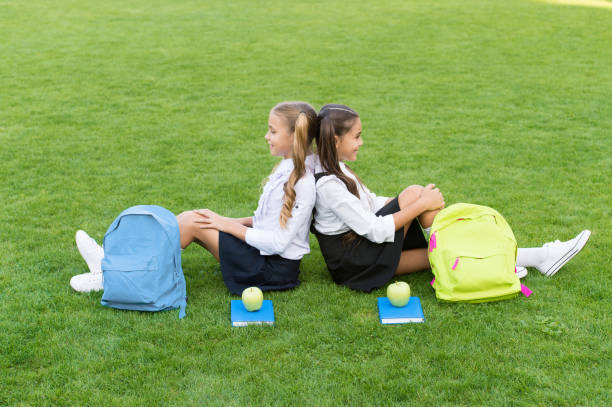 istock School friends relaxing after classes at school yard, trust and support concept 1302268726