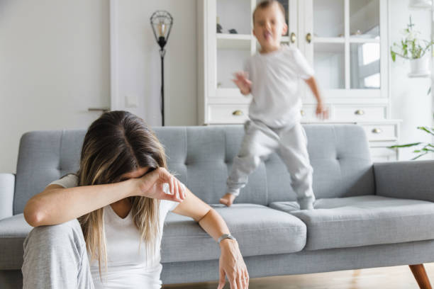 istock Hyperactive child and his tired mother at home 1302268788