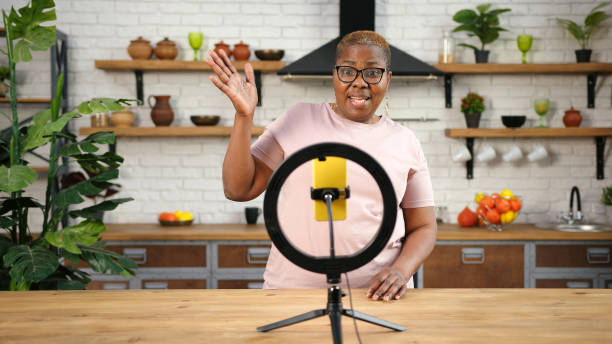istock African-American lady blogger talks looking into smartphone 1302268963
