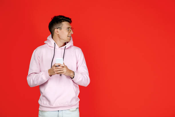 istock Caucasian man's portrait isolated on red studio background with copyspace 1302270491