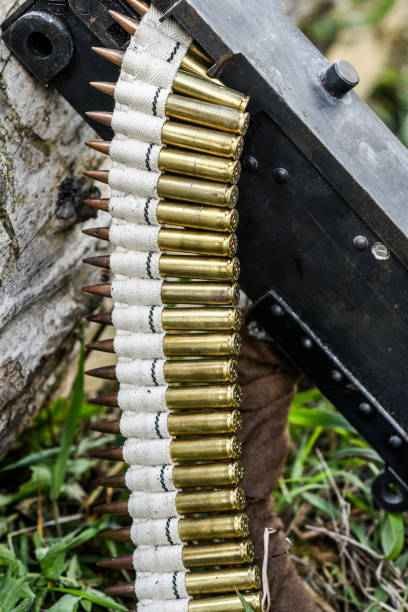 istock Bullets in ammunition belts outdoor for machine gun. 1302270576