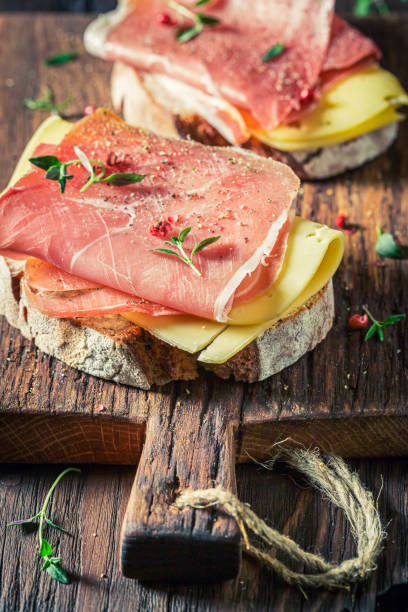 istock Delicious sandwich with cheese, ham and herbs for breakfast 1302270955