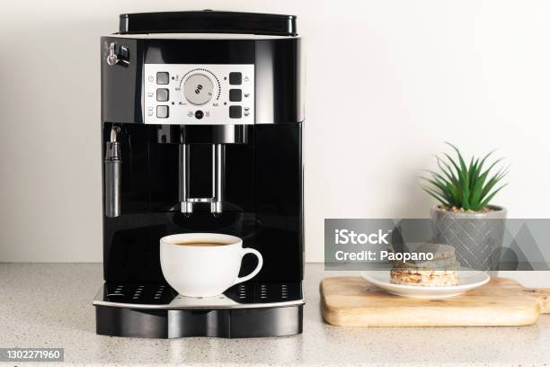 Modern Espresso Coffee Machine With A Cup In Interior Of Kitchen Closeup Stock Photo - Download Image Now