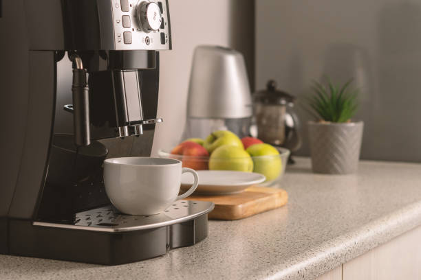 istock Modern espresso coffee machine with a cup in interior of kitchen closeup. 1302271972