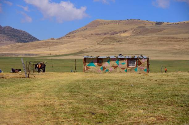Mokhotlong, Lesotho - October 3,2008 : A small Zulu child stand beside his home and looks out onto a great plain and mountain range
