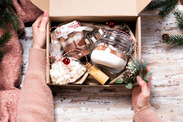 istock Female hands holding Christmas gift box with cookie mix 1302277963