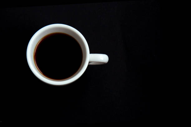 istock Black coffee in a white cup on black background 1302280148