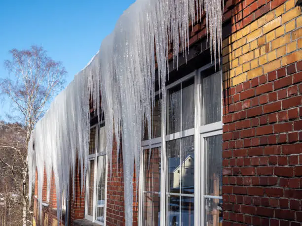 Photo of huge icicles hang from the roof