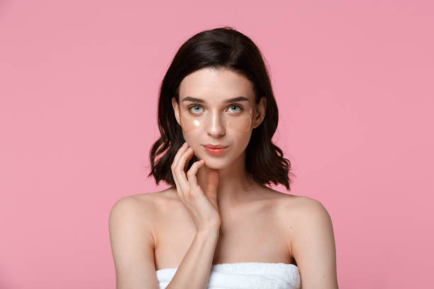 istock Woman applying under eye moisturising patches 1302281783