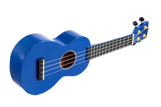 Photo of Guitar musical instrument in blue on a white background. Ukulele. Isolate.