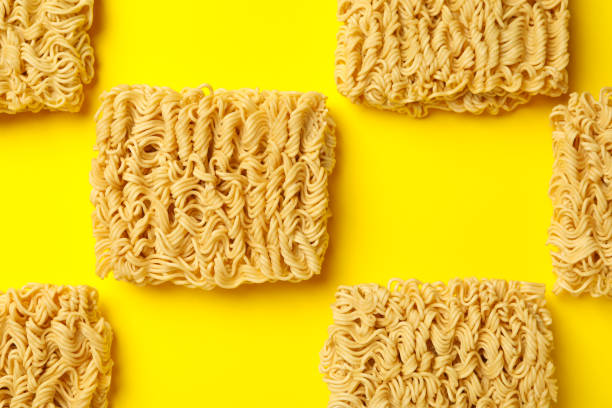 istock Flat lay with instant noodles on yellow background 1302283166