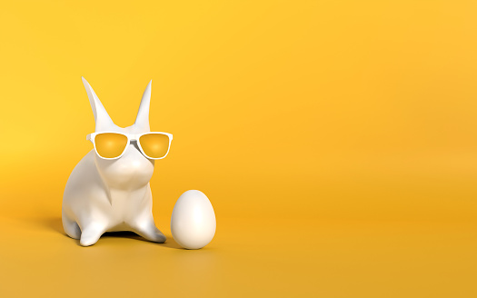 Modern Easter design with a white Easter bunny and egg against yellow background. Easter concept. Easy to crop for all social media and print design sizes.