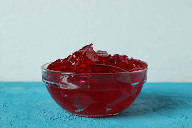 istock Bowl of strawberry jelly on blue table 1302284532