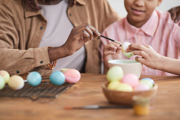 istock Mother and Daughter Painting Easter Eggs Together 1302285821