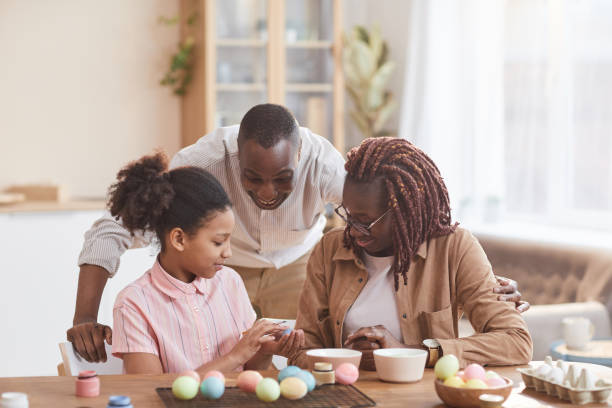 istock Modern African American Family Decorating for Easter 1302285825