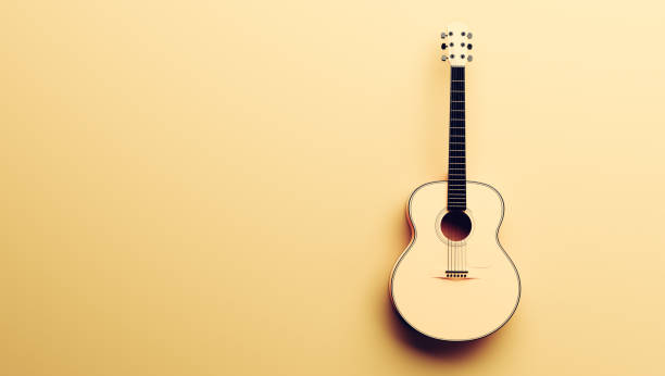 istock Classical acoustic guitar on yellow background. 1302286364