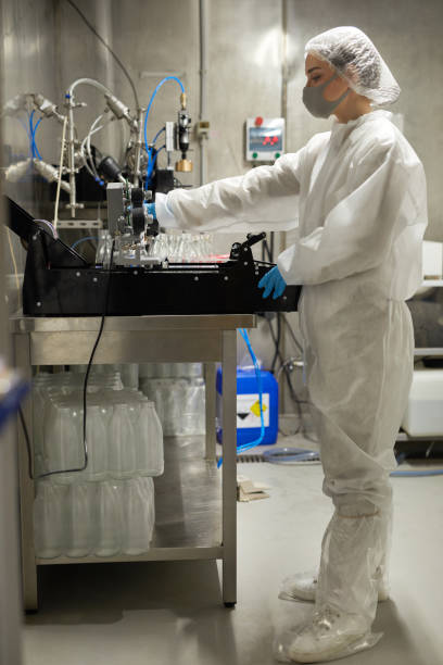istock Female Worker Sterilizing Bottles at Dairy Factory 1302286487