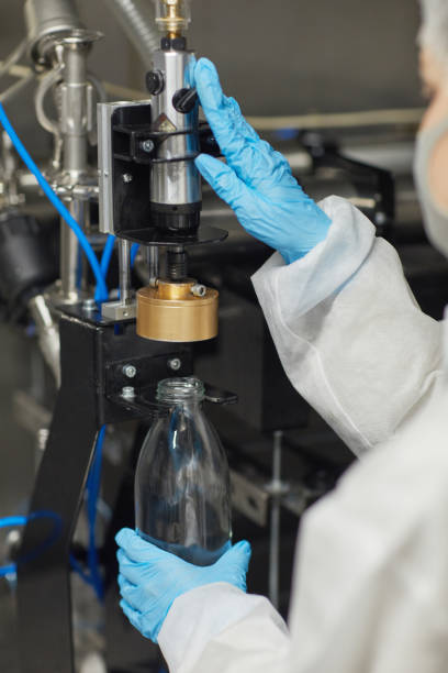 istock Worker Sterilizing Bottles at Food Factory 1302286505