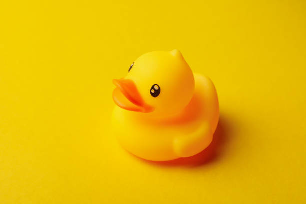 istock Cute rubber duck on yellow background, close up 1302286770
