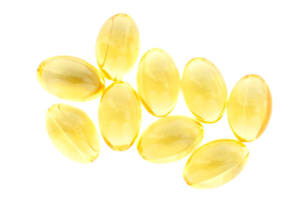 Fish oil gel capsules isolated on white background, top view. Pile of yellow fish oil capsules isolated on white background, top view. Omega-3 fish oil capsules. Close-up of yellow fish oil capsules. Fish oil gel capsules isolated on white background, top view. Pile of yellow fish oil capsules isolated on white background, top view. Omega-3 fish oil capsules. Close-up of yellow fish oil capsules Soft Gel stock pictures, royalty-free photos & images