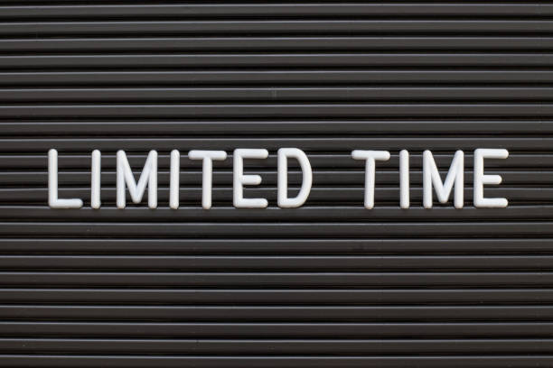 istock Black color felt letter board with white alphabet in word limited time background 1302287593