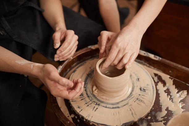 istock Couple Making Ceramics on Pottery Wheel Close Up 1302287734