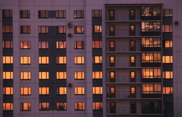 istock Residential building facade with orange sky windows reflection 1302289562