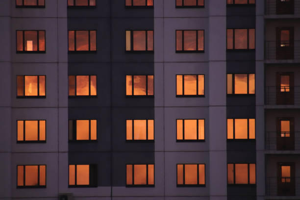 istock Residential house facade with orange sky windows reflection 1302289597