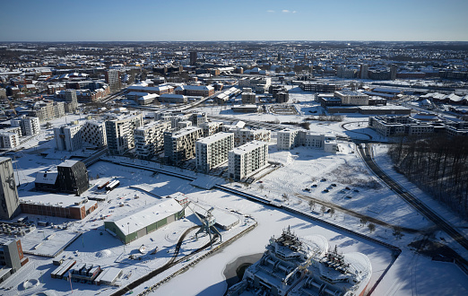 White apartment blocks in aerial view. Odense town Harbor area in Denmark. Winter cold and snow