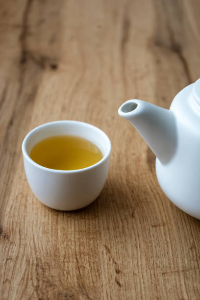 istock A cup of herbal tea and a teapot on a wood table 1302291151